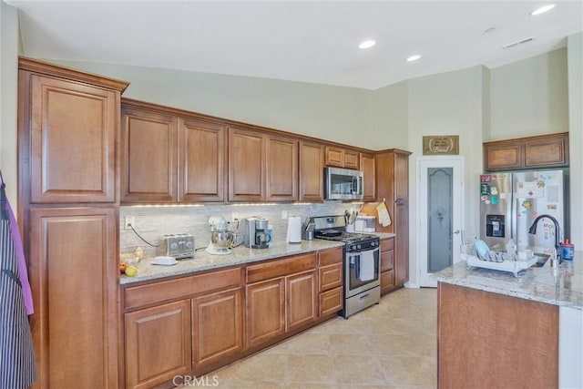32124 Evening Primrose Trl, Campo, CA 91906 - kitchen with appliances with stainless steel finishes, brown cabinets, tasteful backsplash, high vaulted ceiling, and recessed lighting