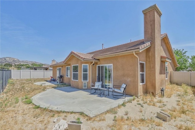 32124 Evening Primrose Trl, Campo, CA 91906 - rear view of property with a fenced backyard, stucco siding, a patio area, and a chimney