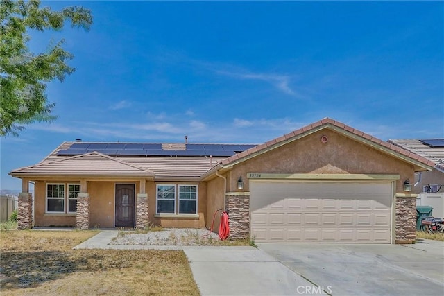 32124 Evening Primrose Trl, Campo, CA 91906 - ranch-style house with stone siding, solar panels, a tiled roof, stucco siding, and a garage