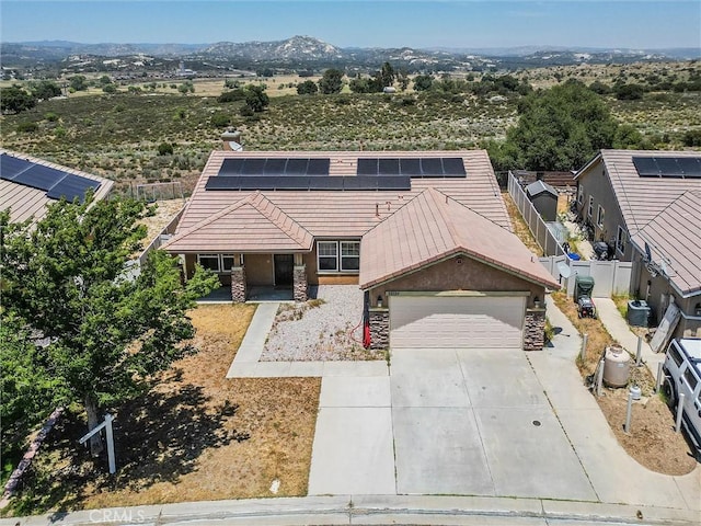 32124 Evening Primrose Trl, Campo, CA 91906 - view of front facade featuring stone siding, a garage, driveway, solar panels, and a porch