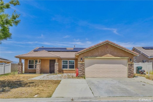 32124 Evening Primrose Trl, Campo, CA 91906 - view of front facade with stone siding, a tiled roof, roof mounted solar panels, a garage, and stucco siding
