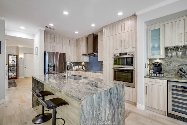 373 W Pebble Creek Ln, Orange, CA 92865 - kitchen featuring appliances with stainless steel finishes, wine cooler, wall chimney range hood, light brown cabinetry, and modern cabinets