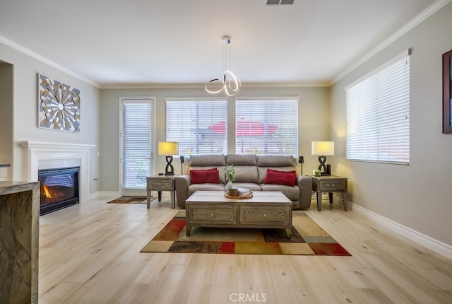373 W Pebble Creek Ln, Orange, CA 92865 - living area featuring light wood finished floors, a fireplace with flush hearth, crown molding, and a chandelier