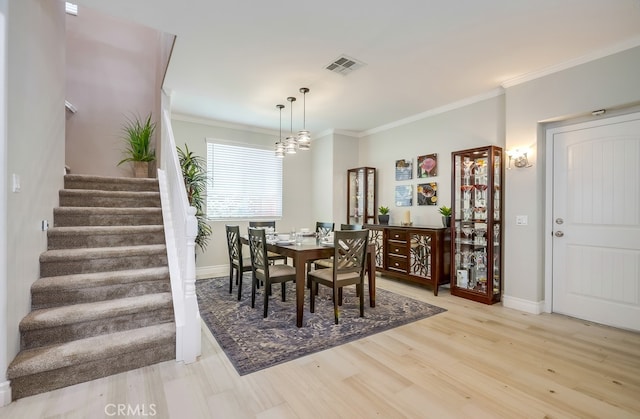 373 W Pebble Creek Ln, Orange, CA 92865 - dining room featuring stairway, ornamental molding, light wood-style floors, and a chandelier
