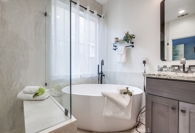 373 W Pebble Creek Ln, Orange, CA 92865 - bathroom featuring vanity, a stall shower, a freestanding bath, and tile walls
