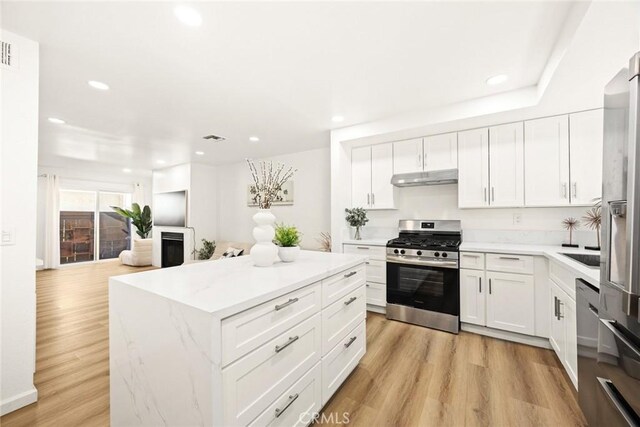 828 N Garfield Ave Unit C, Alhambra, CA 91801 - kitchen featuring stainless steel appliances, under cabinet range hood, recessed lighting, white cabinetry, and a kitchen island