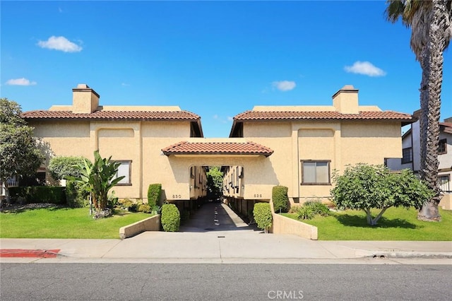 828 N Garfield Ave Unit C, Alhambra, CA 91801 - mediterranean / spanish-style house with a chimney, stucco siding, and a front lawn