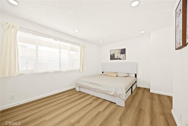 828 N Garfield Ave Unit C, Alhambra, CA 91801 - bedroom with wood finished floors, a textured ceiling, and recessed lighting
