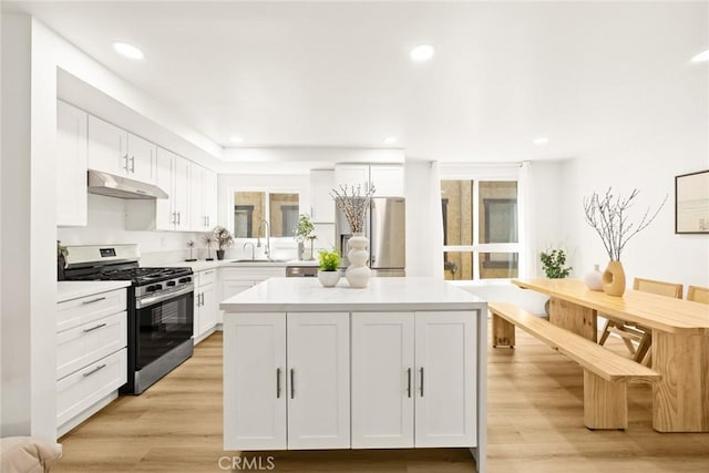 828 N Garfield Ave Unit C, Alhambra, CA 91801 - kitchen with stainless steel gas range, under cabinet range hood, white cabinetry, light countertops, and recessed lighting
