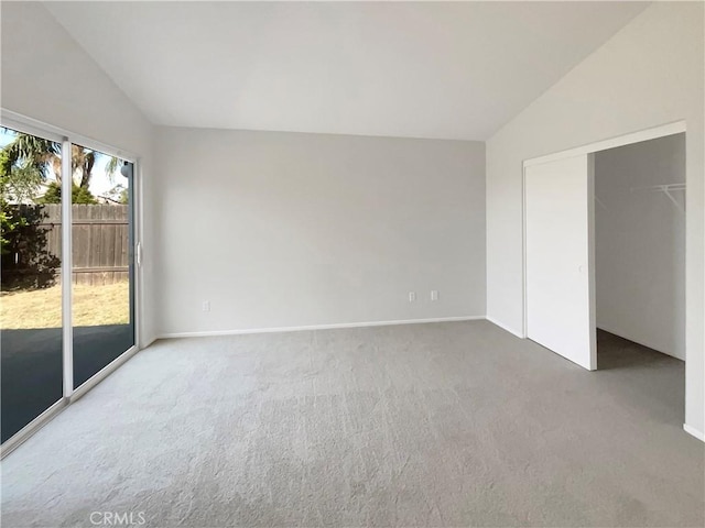 995 Northpark Blvd, San Bernardino, CA 92407 - unfurnished bedroom featuring vaulted ceiling, access to exterior, carpet, and a closet