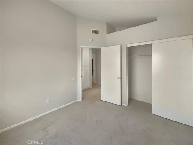 995 Northpark Blvd, San Bernardino, CA 92407 - unfurnished bedroom featuring carpet, a closet, and high vaulted ceiling