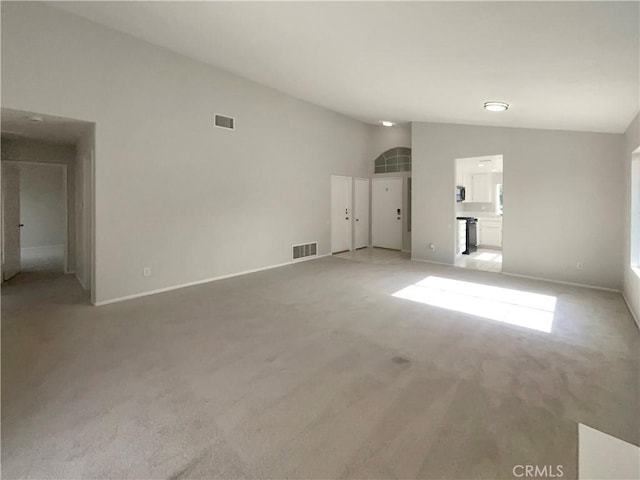 995 Northpark Blvd, San Bernardino, CA 92407 - unfurnished living room with vaulted ceiling and light colored carpet