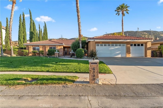 6720 Sycamore Ln, Palmdale, CA 93551 - view of front facade featuring stucco siding, concrete driveway, a tile roof, a mountain view, and a garage