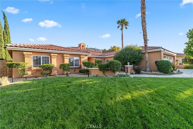6720 Sycamore Ln, Palmdale, CA 93551 - mediterranean / spanish-style house with a front yard, stucco siding, and a tile roof