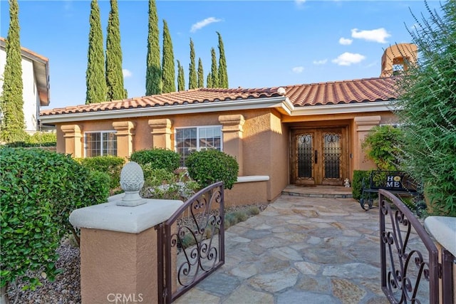 6720 Sycamore Ln, Palmdale, CA 93551 - view of front of house featuring french doors, a tile roof, and stucco siding