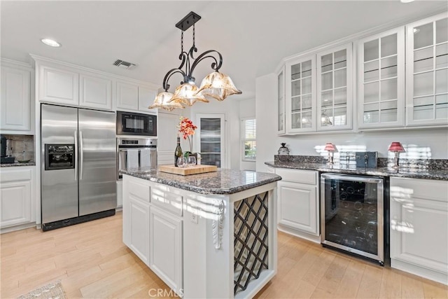 6720 Sycamore Ln, Palmdale, CA 93551 - kitchen with stainless steel appliances, wine cooler, a center island, light wood finished floors, and recessed lighting