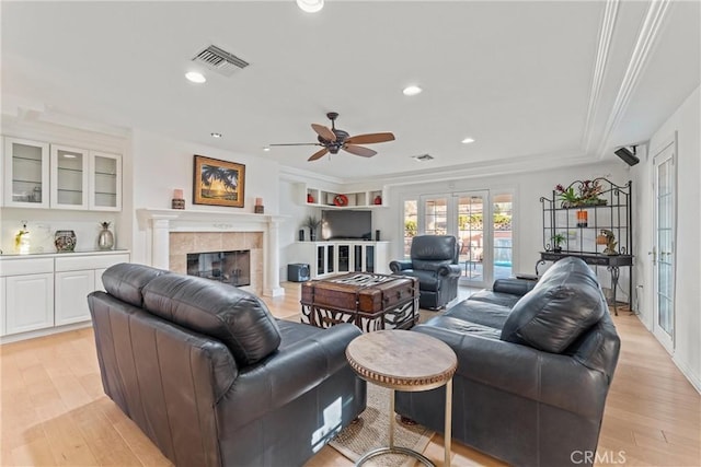 6720 Sycamore Ln, Palmdale, CA 93551 - living area with ceiling fan, light wood-type flooring, a tiled fireplace, recessed lighting, and ornamental molding