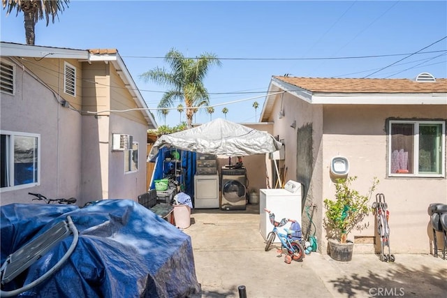 215 E 11th St Unit 4, Pomona, CA 91766 - view of home's exterior with separate washer and dryer, stucco siding, and a patio