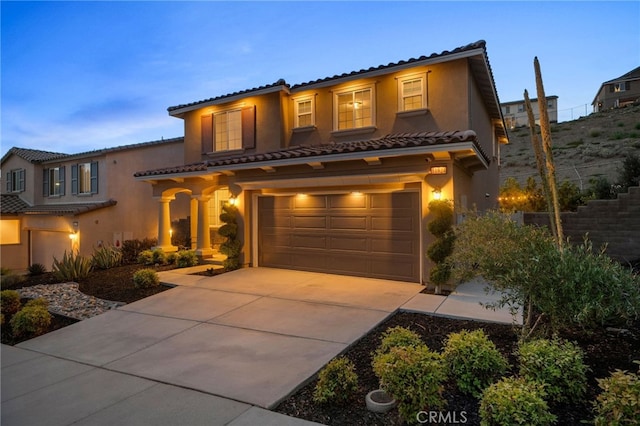 11824 Stonefield Dr, Corona, CA 92883 - mediterranean / spanish house with a garage, a tile roof, driveway, and stucco siding