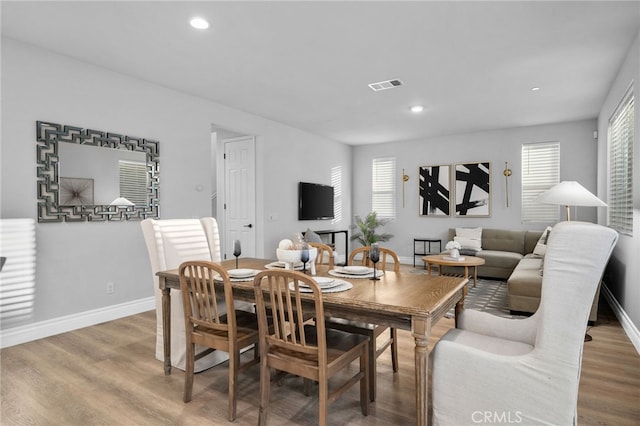 11824 Stonefield Dr, Corona, CA 92883 - dining room with healthy amount of natural light, wood finished floors, and recessed lighting