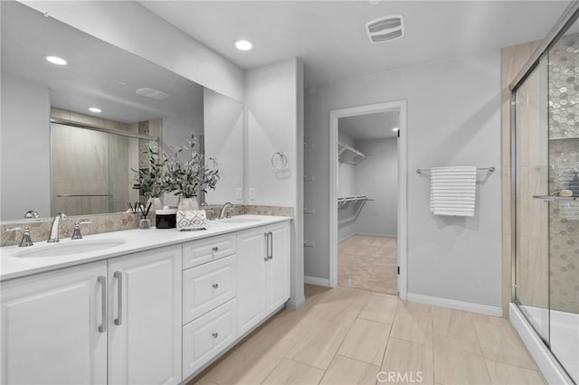 11824 Stonefield Dr, Corona, CA 92883 - bathroom featuring a stall shower, a walk in closet, double vanity, and recessed lighting