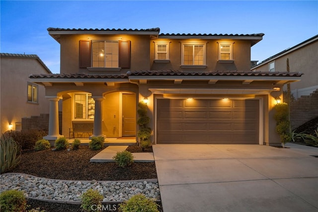 11824 Stonefield Dr, Corona, CA 92883 - mediterranean / spanish home with a tile roof, driveway, an attached garage, covered porch, and stucco siding