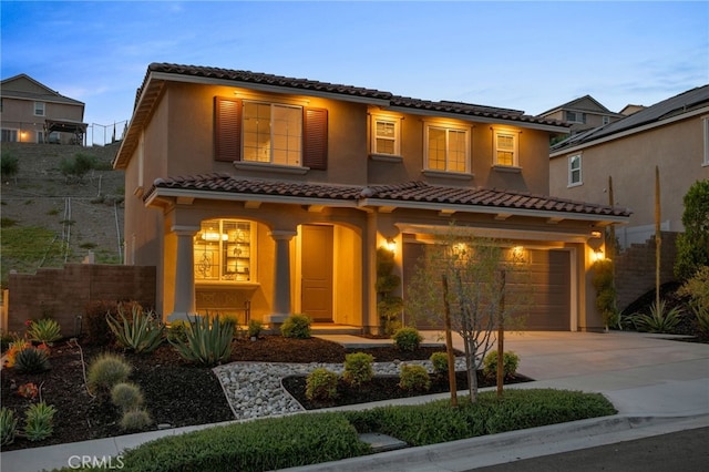 11824 Stonefield Dr, Corona, CA 92883 - mediterranean / spanish-style home with a tiled roof, driveway, a garage, stucco siding, and covered porch