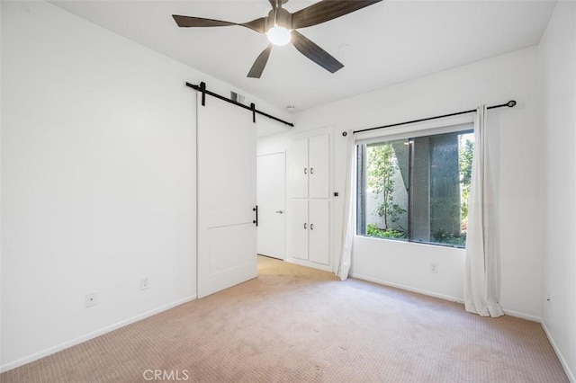 4822 Tiara Dr Unit 104, Huntington Beach, CA 92649 - spare room featuring a barn door, light carpet, and a ceiling fan