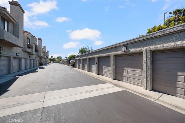 4822 Tiara Dr Unit 104, Huntington Beach, CA 92649 - view of concrete road featuring community garages and a residential view