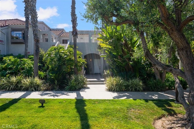 4822 Tiara Dr Unit 104, Huntington Beach, CA 92649 - view of front of house featuring a front lawn and stucco siding