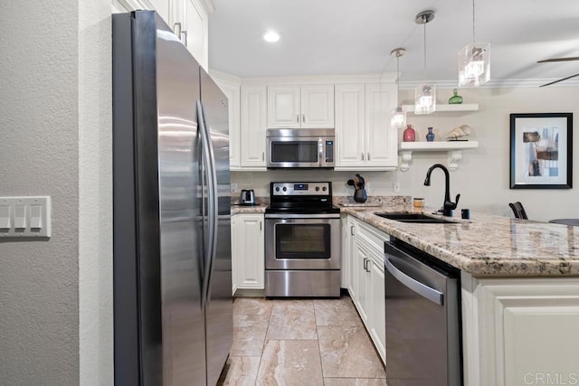 999 N Pacific St Unit A208, Oceanside, CA 92054 - kitchen featuring appliances with stainless steel finishes, white cabinets, light stone counters, pendant lighting, and open shelves