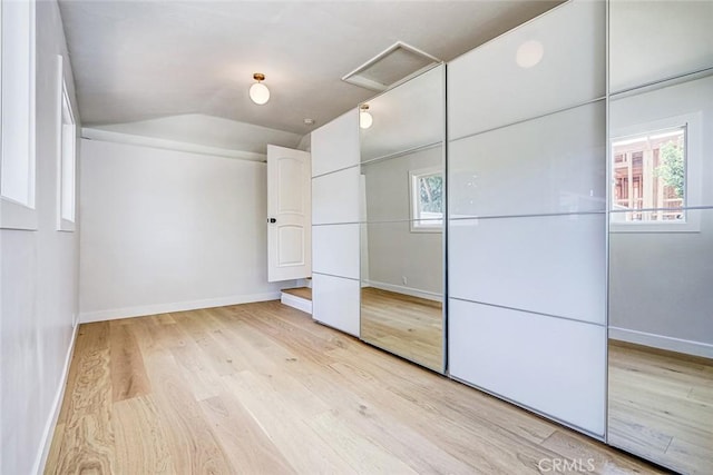 708 S Redondo Ave, Manhattan Beach, CA 90266 - unfurnished bedroom with attic access, light wood finished floors, lofted ceiling, and a closet