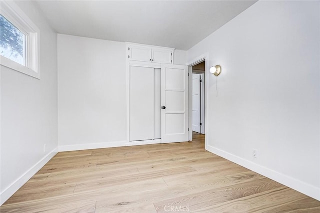 708 S Redondo Ave, Manhattan Beach, CA 90266 - unfurnished bedroom with light wood-style flooring and baseboards