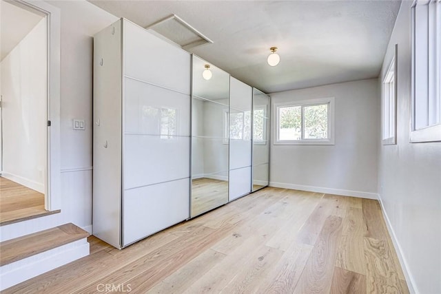 708 S Redondo Ave, Manhattan Beach, CA 90266 - unfurnished bedroom featuring attic access and light wood-style flooring