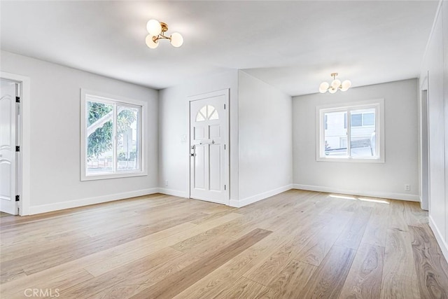 708 S Redondo Ave, Manhattan Beach, CA 90266 - entryway featuring light wood finished floors and a chandelier