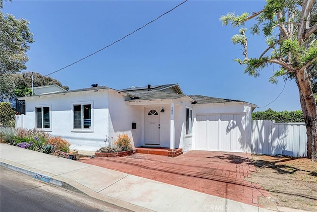 708 S Redondo Ave, Manhattan Beach, CA 90266 - view of front of property featuring stucco siding, roof mounted solar panels, and roof with shingles