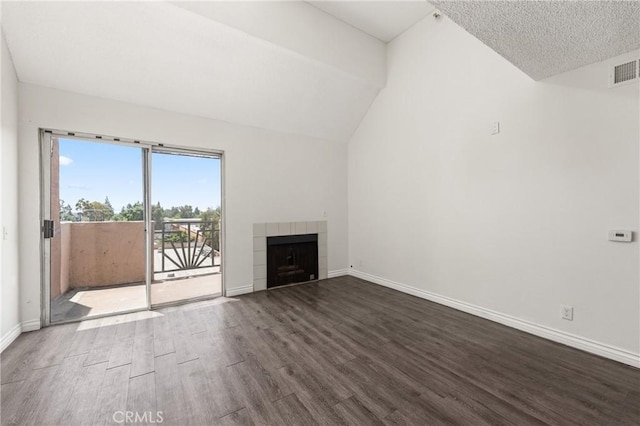 450 E 4th St Unit 419, Santa Ana, CA 92701 - unfurnished living room featuring wood finished floors, a tile fireplace, and lofted ceiling