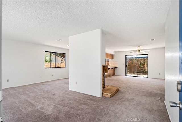 37224 Halfmoon Dr, Palmdale, CA 93550 - unfurnished living room featuring carpet, ceiling fan, and a textured ceiling