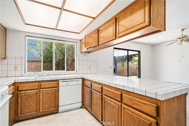37224 Halfmoon Dr, Palmdale, CA 93550 - kitchen featuring white dishwasher, a peninsula, plenty of natural light, and range