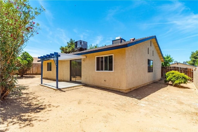 37224 Halfmoon Dr, Palmdale, CA 93550 - rear view of property featuring a pergola, a patio area, stucco siding, and a chimney