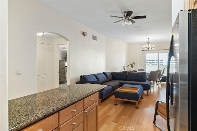 2750 Artesia Blvd Unit 313, Redondo Beach, CA 90278 - living room with a ceiling fan, light wood-type flooring, arched walkways, and a chandelier