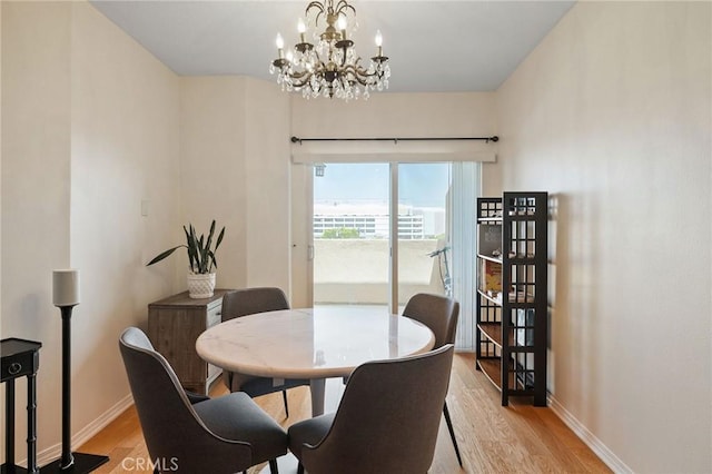 2750 Artesia Blvd Unit 313, Redondo Beach, CA 90278 - dining area featuring light wood-style floors and a chandelier