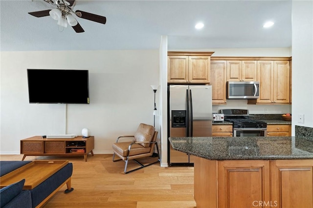 2750 Artesia Blvd Unit 313, Redondo Beach, CA 90278 - kitchen featuring appliances with stainless steel finishes, light wood finished floors, a ceiling fan, dark stone countertops, and recessed lighting
