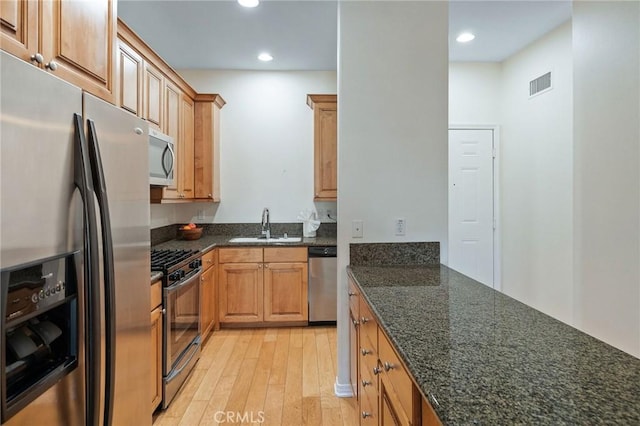 2750 Artesia Blvd Unit 313, Redondo Beach, CA 90278 - kitchen featuring appliances with stainless steel finishes, light wood finished floors, recessed lighting, and dark stone countertops