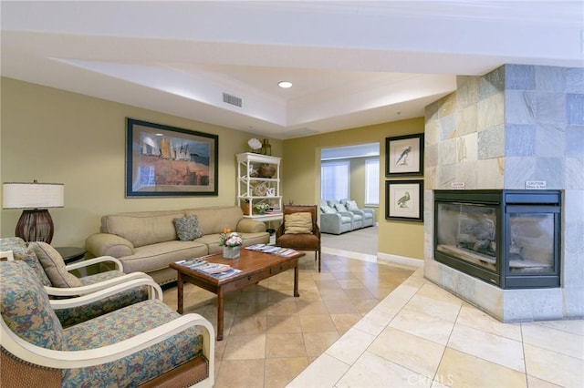 2750 Artesia Blvd Unit 313, Redondo Beach, CA 90278 - living room featuring a tray ceiling, a tile fireplace, light tile patterned floors, and recessed lighting