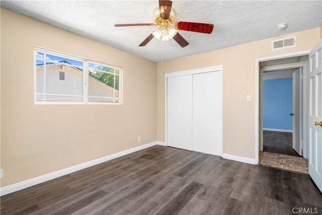 43236 W 20th St W, Lancaster, CA 93534 - unfurnished bedroom featuring dark wood-style floors, a textured ceiling, a closet, and ceiling fan