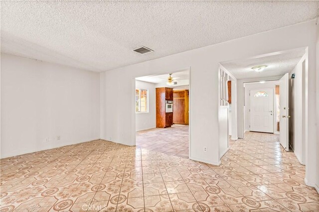 43236 W 20th St W, Lancaster, CA 93534 - spare room with a textured ceiling, light tile patterned floors, and ceiling fan