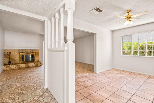 43236 W 20th St W, Lancaster, CA 93534 - unfurnished living room featuring a textured ceiling, light tile patterned flooring, a brick fireplace, and ceiling fan