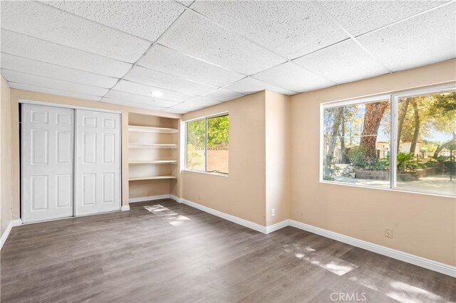 43236 W 20th St W, Lancaster, CA 93534 - unfurnished bedroom featuring wood finished floors, a closet, and a drop ceiling