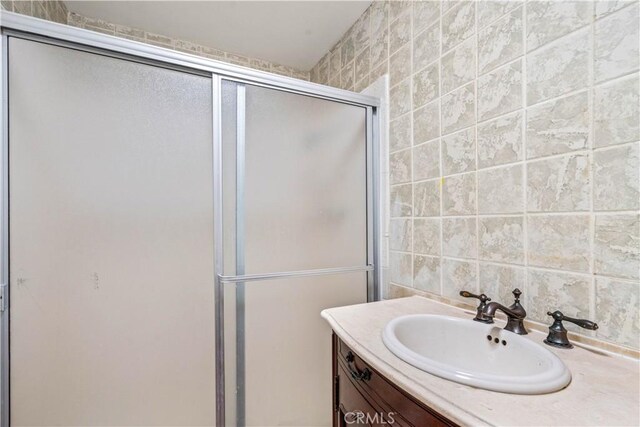 43236 W 20th St W, Lancaster, CA 93534 - full bath featuring a stall shower, vanity, tile walls, and decorative backsplash